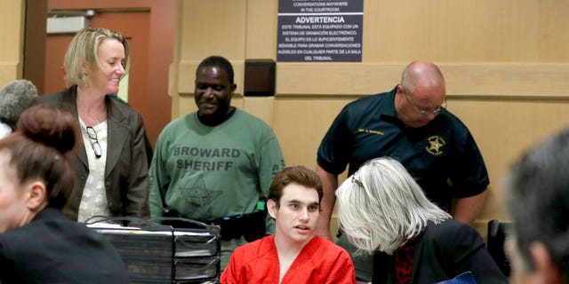 The Parkland school gun suspect, Nikolas Cruz, speaks with his lawyer in court to present a motion for defense at the Broward courthouse in Fort Lauderdale, Florida on Thursday, April 18, 2019.