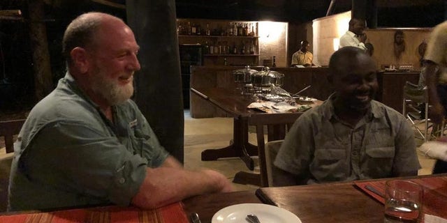 Safari guide Jean-Paul Mirenge Ramezo, right, after he was rescued.