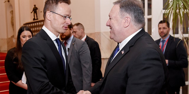 U.S. Secretary of State Mike Pompeo is welcomed by Hungary's Minister of Foreign Affairs and Trade Peter Szijjarto in the ministry building in Budapest, Hungary, February 11, 2019. (Attila Kisbenedek/Pool via Reuters)