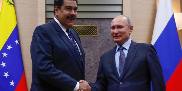 Russian President Vladimir Putin, right, shakes hands with his Venezuelan counterpart Nicolas Maduro