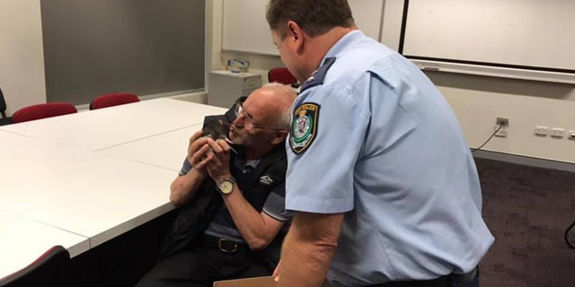 The man leaned in for a kiss with his rat.