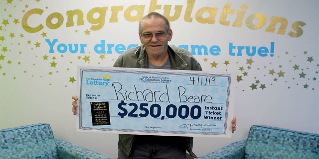 Richard Beare collected his big prize from the winning scratch-off ticket Monday.