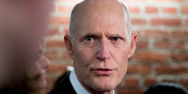 Sen. Rick Scott, R-Fla., speaks to reporters outside his office on Capitol Hill in Washington, Wednesday, Jan. 23, 2019. Scott took questions on Venezuela and the government shutdown. (AP Photo/Andrew Harnik)