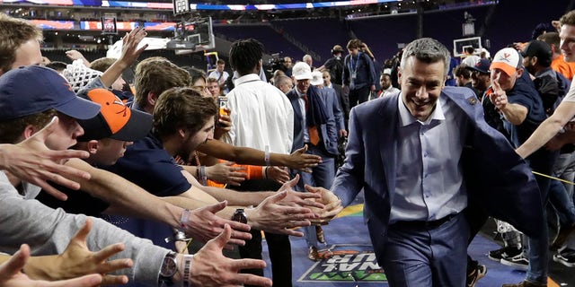 Virginia head coach Tony Bennett celebrates with fans after the championship game against Texas Tech in the Final Four NCAA college basketball tournament, Monday, April 8, 2019, in Minneapolis. Virginia won 85-77 in overtime. (AP Photo/David J. Phillip)