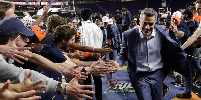 Virginia head coach Tony Bennett celebrates with fans after the championship game against Texas Tech in the Final Four NCAA college basketball tournament, Monday, April 8, 2019, in Minneapolis. Virginia won 85-77 in overtime. (AP Photo/David J. Phillip)