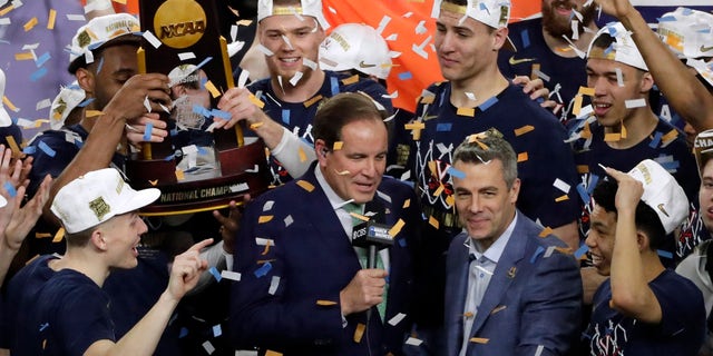 Virginia head coach Tony Bennett, right, celebrates with his team after the championship game against Texas Tech in the Final Four NCAA college basketball tournament, Monday, April 8, 2019, in Minneapolis. Virginia won 85-77 in overtime.(AP Photo/Matt York)