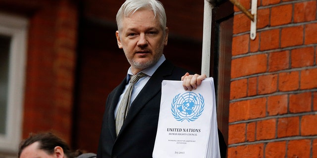 In this Friday, Feb. 5, 2016 file photo, WikiLeaks founder Julian Assange stands on the balcony of the Ecuadorean Embassy to address waiting supporters and media in London. 