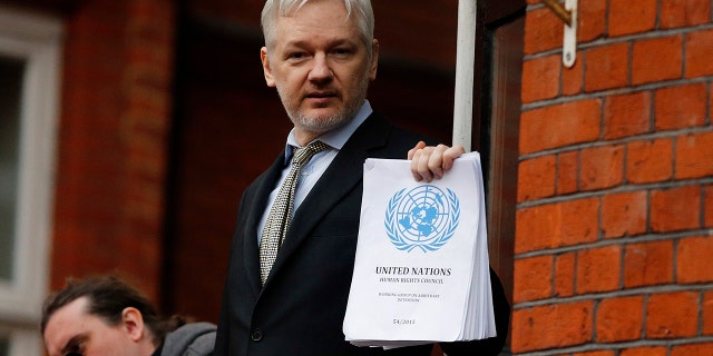 In this Friday, Feb. 5, 2016 file photo, WikiLeaks founder Julian Assange stands on the balcony of the Ecuadorean Embassy to address waiting supporters and media in London.