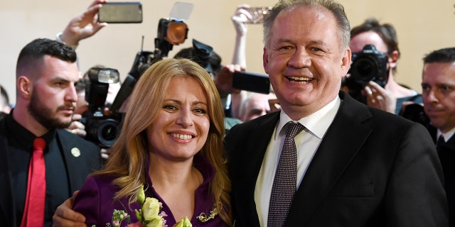 Slovakia's current president Andrej Kiska poses with president-elect Zuzana Caputova at her party's headquarters in Bratislava, Slovakia, March 30, 2019.