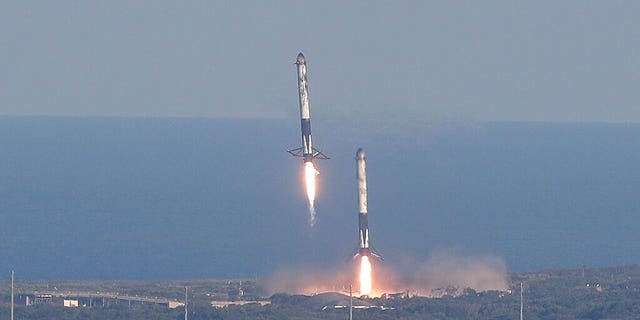 Eight minutes after liftoff, SpaceX lands two of the first-stage boosters side by side at the Kennedy Space Center in Cape Canaveral, Fla., Thursday, April 11, 2019.
