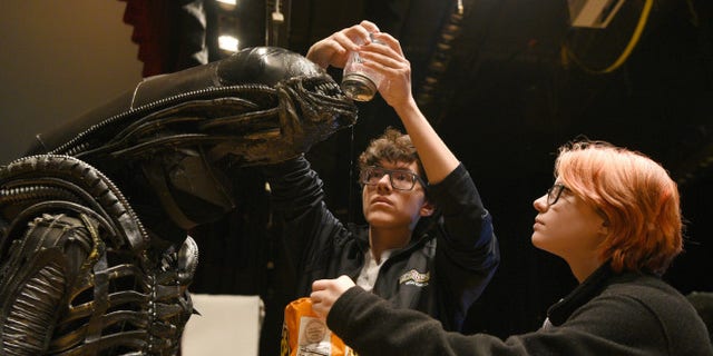 North Bergen High School's Xavier Perez, 16, the Alien, is covered in slime by his handlers Eddie Mantilla, 15, and Cassandra Klima, 16, as they work on the play "Alien," an adaptation of the Ridley Scott movie, in North Bergen, N.J.