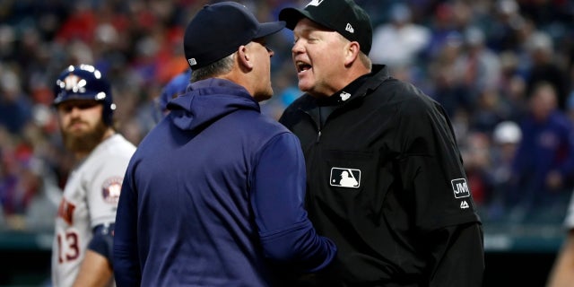 Houston Astros manager AJ Hinch argues with umpire Ron Kulpa, right, during the second inning of the team's baseball game against the Texas Rangers in Arlington, Texas, Wednesday, April 3, 2019.