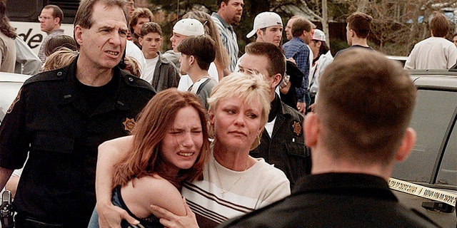 A woman embraces her daughter after they were reunited following the Columbine High School shooting. (AP/File)