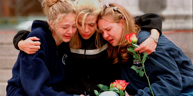 In this April 1999 file photo, Rachel Ruth, Rhianna Cheek and Mandi Annibel, all 16-year-old sophomores at Heritage High School in Littleton, Colo., console each other during a vigil service to honor the victims of the shooting spree in Columbine High School. (Associated Press)