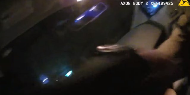 Groton Officer Tyler DeAngelo can be seen struggling to stay in a car as a suspect drove away in February 2018.