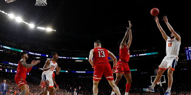 Virginia's Ty Jerome (11) makes a shot against Texas Tech's Kyler Edwards (0) during the second half in the championship of the Final Four NCAA college basketball tournament, Monday, April 8, 2019, in Minneapolis. (AP Photo/David J. Phillip)