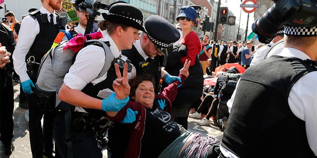 Police arrest protesters at Oxford Circus in London on Friday.