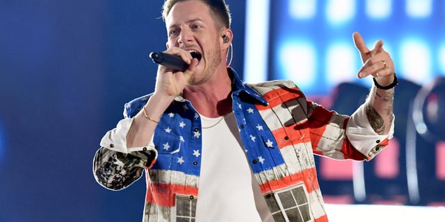 Florida Georgia Line's Tyler Hubbard, wearing an American flag jacket and jeans, performs at the 2019 ACM Awards in Las Vegas.