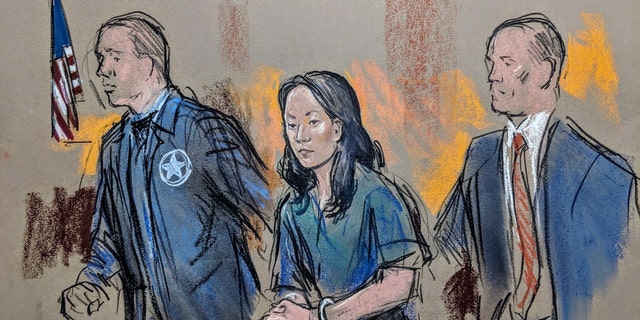 ​Yujing Zhang being led into federal court in West Palm Beach, Fla., in April.