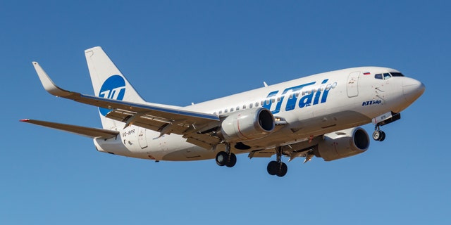 Moscow, Russia - April 03, 2019: Aircraft Boeing 737-524(WL) VQ-BPR of UTair Aviation going to landing against blue sky at Vnukovo international airport in Moscow at sunny day