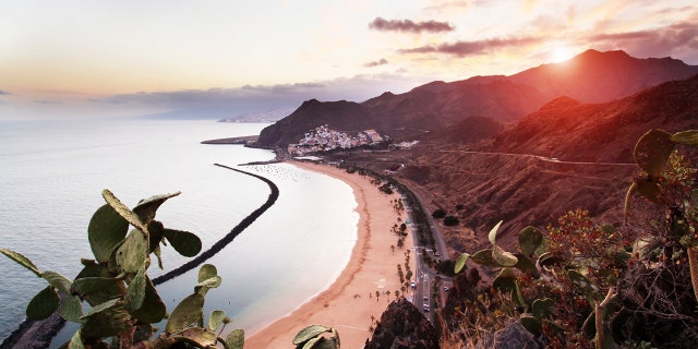 View of Playa de Las Teresitas, Sant Andres and Santa Cruz de Tenerife at sunset.