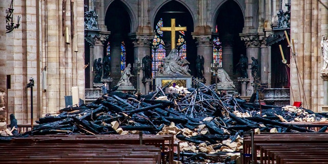 A view of the debris inside Notre-Dame de Paris in the aftermath of a fire that devastated the cathedral, during the visit of French Interior Minister Christophe Castaner (not pictured) in Paris, France, April 16, 2019. Christophe Petit Tesson/Pool via REUTERS - RC12F77ABC70