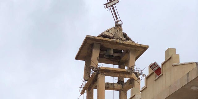 The bell tower of St. Adday Church in Karamles, a town the Knights of Columbus helped rebuild. The crooked cross is still standing despite the demotion of ISIS in the region.