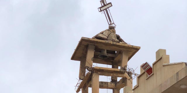 The bell tower of St. Adday Church in Karamles, a town the Knights of Columbus helped rebuild. The crooked cross is still standing despite the demotion of ISIS in the region.