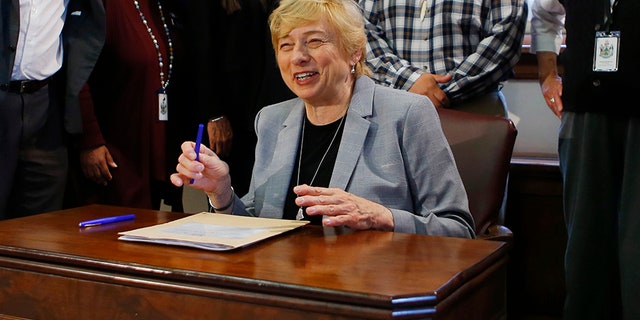 Maine Gov. Janet Mills is shown here signing a bill Friday to establish Indigenous Peoples' Day. Mills added Maine to the growing number of states changing Columbus Day to Indigenous Peoples' Day. She also is supporting a push to make the wording of the state's laws more gender-neutral.