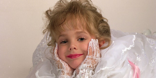 May 1, 1994 - JonBenet Ramsey, very happy, all in white, wearing white lace gloves laying down on a white seamless at a studio session for a commercial ad and actress portfolio.