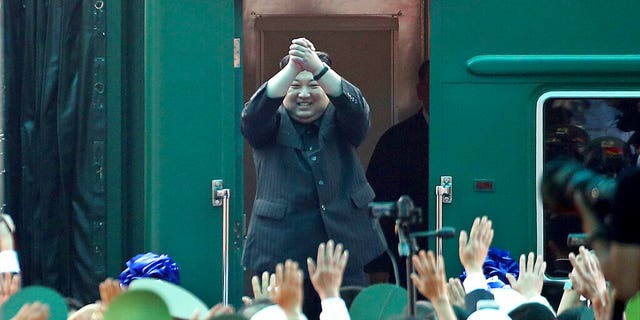 In this March 2, 2019, file photo, North Korean leader Kim Jong Un waves from his train as he arrives at the railway station in Dong Dang, Vietnam.