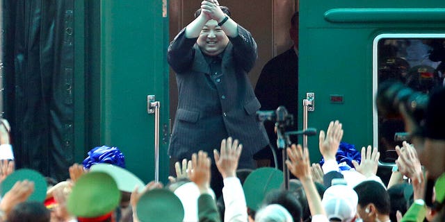 In this March 2, 2019, file photo, North Korean leader Kim Jong Un waves from his train as he arrives at the railway station in Dong Dang, Vietnam.