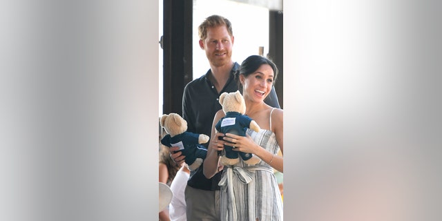 Britain's Prince Harry and his wife Meghan, the Duchess of Sussex attend a meet-the-people walk at Kingfisher Bay Resort on Fraser Island on October 22, 2018.