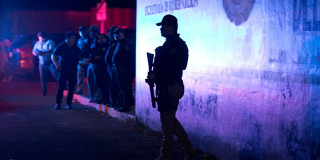 A Federal Police Officer Stands Offside an Immigration Detention Center in Tapachula, Chiapas State, Mexico, late Thursday, following a breakout. stands guard outside an immigration detention center in Tapachula, Chiapas state, Mexico, late Thursday, following a breakout.
<span class=