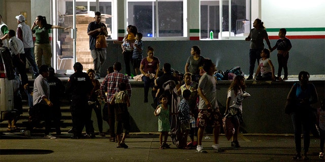 Migrants wait for their transfer from an immigration detention center in Tapachula, Chiapas state, Mexico, on Thursday