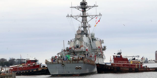 Tugboats maneuver the guided-missile destroyer USS Arleigh Burke (DDG 51) in position for dry-docking in preparation for the ship’s Extended Dry-Docking Selected Restricted Availability (EDSRA).