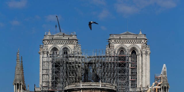 A pigeon flies over Notre-Dame de Paris Cathedral on Friday, April 19, 2019. The reconstruction of Notre-Dame, the 800-year-old Parisian cathedral devastated by fire, will cost billions of dollars as architects, historians and artisans work to preserve the medieval monument. (AP Photo / Thibault Camus)