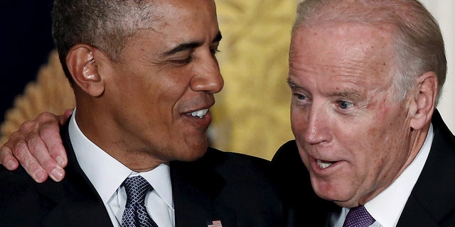 U.S. Vice President Joe Biden (R) interjects as President Barack Obama delivers remarks at a reception for the 25th anniversary of the White House Initiative on Educational Excellence for Hispanics at the White House in Washington, October 15, 2015. REUTERS/Jonathan Ernst - GF10000246643