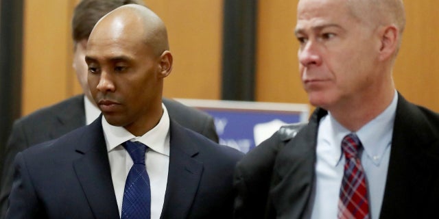 The former Minneapolis police officer, Mohamed Noor, in the center, is accompanied by his lawyers, Peter Wold, unrepresented, and Thomas Plunkett, on the right, as he heads for the government center of Hennepin County for the oral arguments of its trial, Tuesday, April 9, 2019.