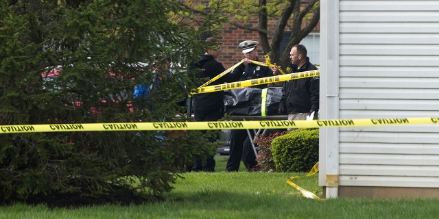 A body is loaded into a Butler County coroner's van Monday, April 29, 2019 after multiple people were found dead at the Lakefront at West Chester apartment complex in West Chester Township, Ohio on Sunday night, according to police.