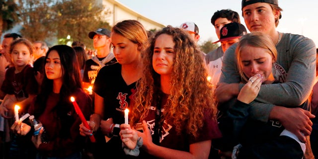 Mourners react during a candlelight vigil for the victims of the Marjory Stoneman Douglas High School shooting in Parkland, Florida on February 15, 2018. (RHONA WISE/AFP/Getty Images)