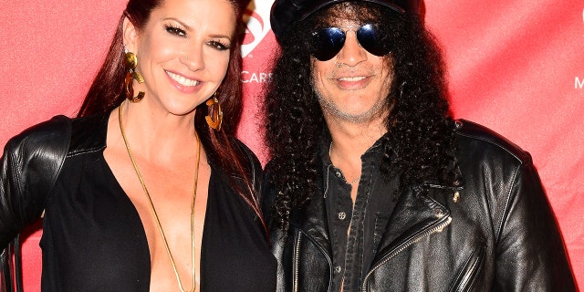 Musician Slash, right, and now-ex-wife Perla Hudson arrive at the MusiCares MAP Fund Benefit Concert at Club Nokia on May 12, 2014 in Los Angeles.