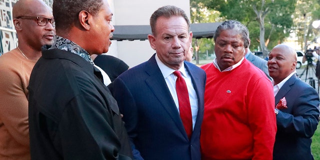Broward County Sheriff Scott Israel, center, leaves a news conference surrounded by supporters after Florida Gov. Ron DeSantis suspended him in January.