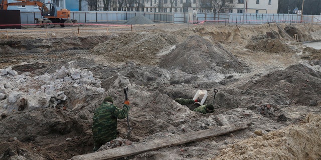 Soldiers from a special "search battalion" of Belarus Defence Ministry take part in the exhumation of a mass grave containing the remains of about 730 prisoners of a former Jewish ghetto, discovered at a construction site in the center of Brest, Belarus February 26, 2019.