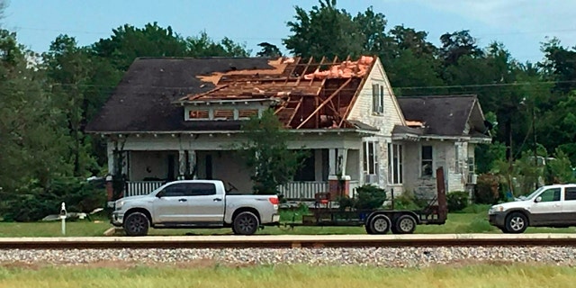 A roof is torn in a house following an alleged tornado on Saturday, April 13, 2019 in Franklin, Texas.