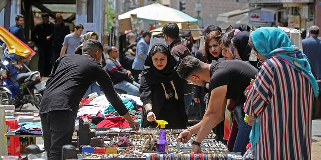 Iranians shop at an open market in the Islamic republic's capital Tehran, on April 24, 2019. - Iranians, already hard hit by punishing US economic sanctions, are bracing for more pain after Washington abolished waivers for some countries which had allowed them to buy oil from Iran.