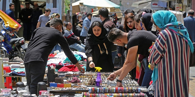 Iranians shop at an open market in the Islamic republic's capital Tehran, on April 24, 2019. - Iranians, already hard hit by punishing US economic sanctions, are bracing for more pain after Washington abolished waivers for some countries which had allowed them to buy oil from Iran.