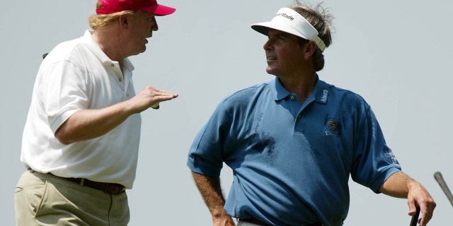 Donald Trump, left, talks with Fred Couples as they leave the 14th hole of the Buick Classic Pro-Am golf tournament in Harrison, NY, Wednesday, June 9, 2004.