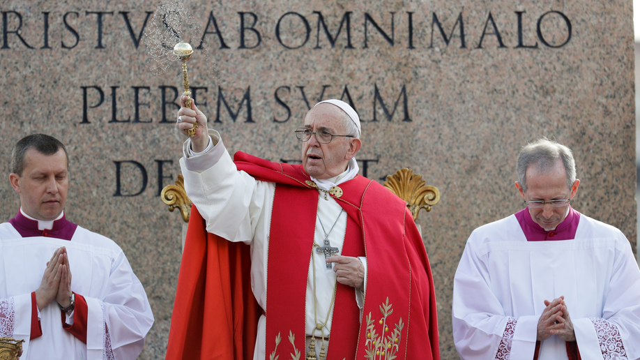 Pope Francis blesses palm branches as he ushers in Holy Week