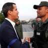 Venezuelan opposition leader Juan Guaido, who many nations have recognized as the country's rightful interim ruler, shakes hands with a military member near the Generalisimo Francisco de Miranda Airbase, in Caracas, April 30, 2019. 